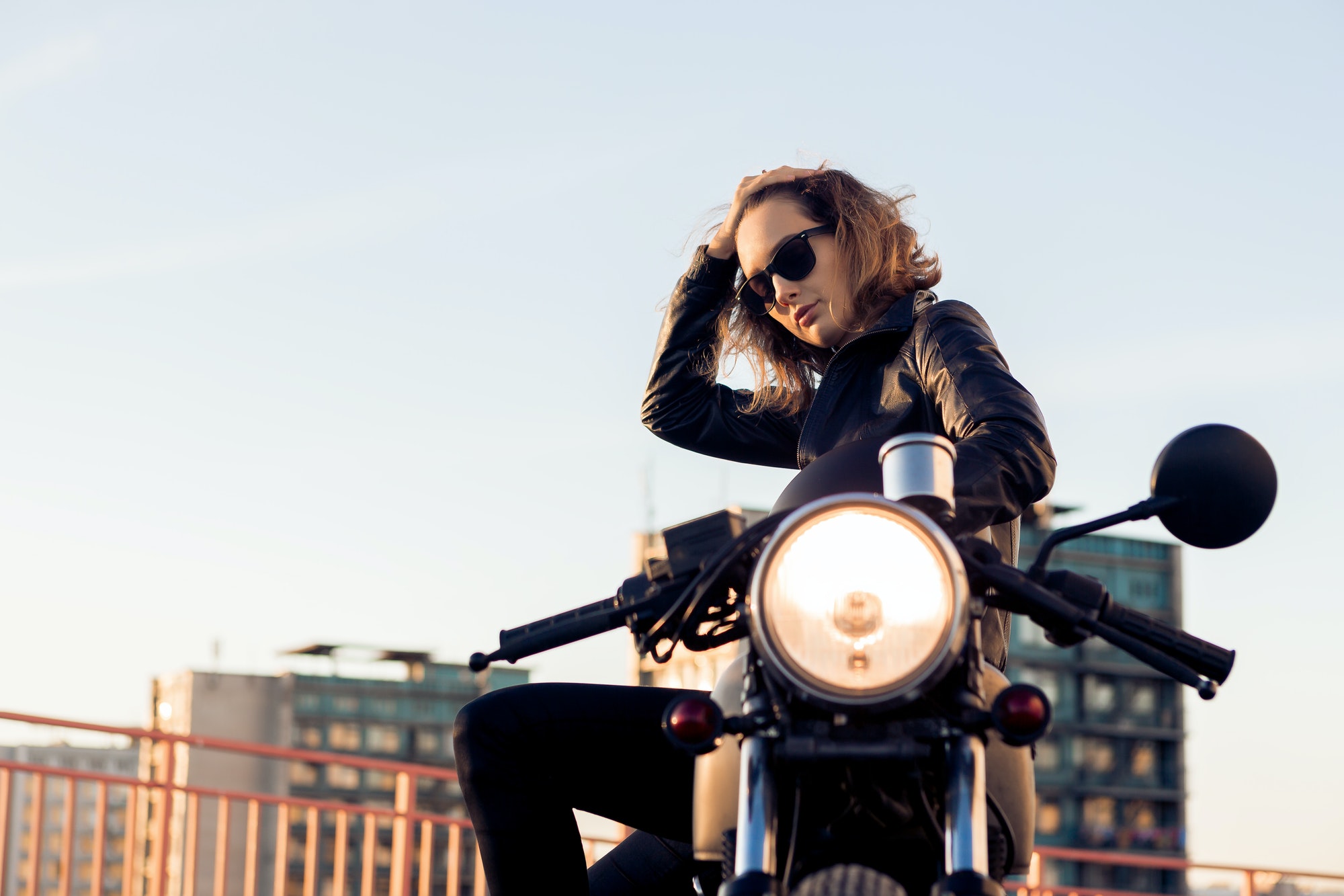 Biker girl on caferacer motorcycle.